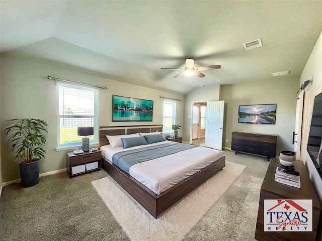 bedroom with vaulted ceiling, multiple windows, visible vents, and carpet floors