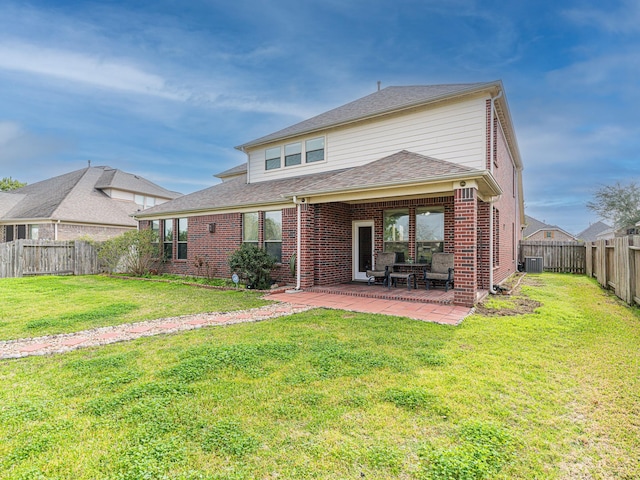 rear view of property with a patio, a yard, and central AC unit