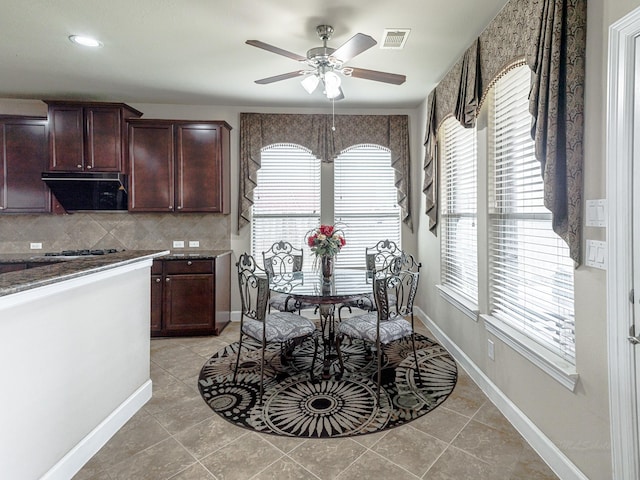 dining space featuring light tile patterned floors and ceiling fan