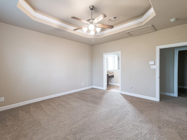 unfurnished bedroom featuring crown molding, carpet floors, and a raised ceiling