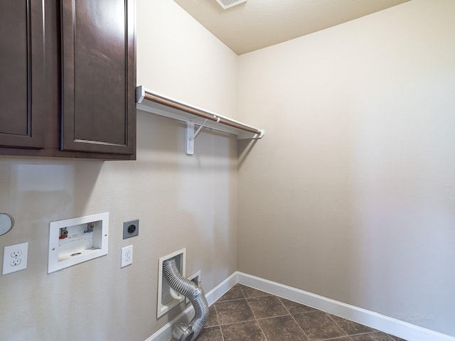 washroom featuring cabinets, electric dryer hookup, hookup for a washing machine, and dark tile patterned floors