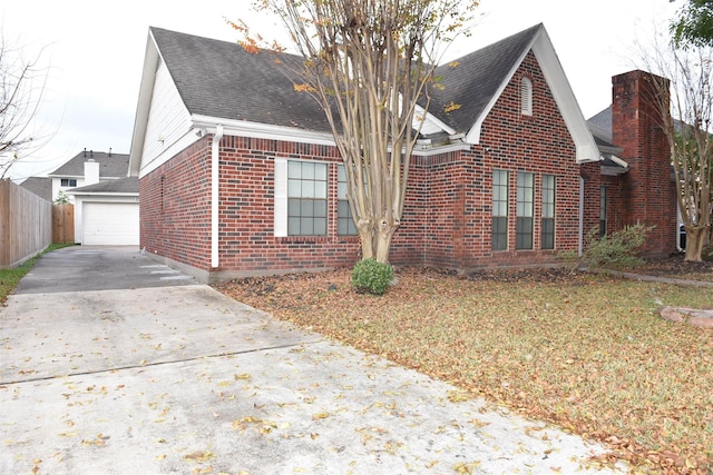 view of property exterior featuring a garage and an outdoor structure