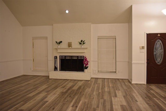 unfurnished living room with hardwood / wood-style floors and a fireplace