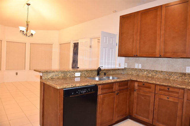 kitchen with pendant lighting, tasteful backsplash, dishwasher, sink, and light stone counters