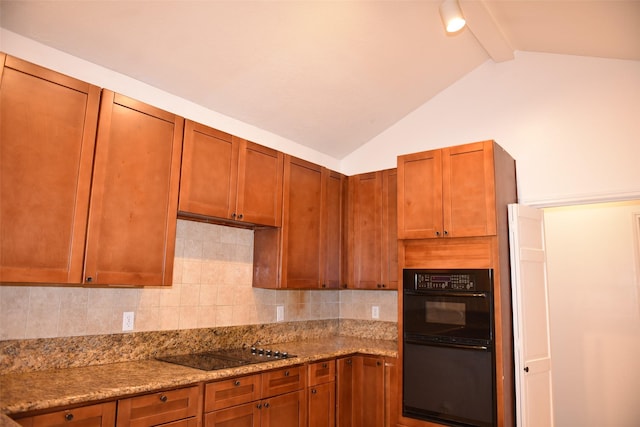 kitchen with tasteful backsplash, vaulted ceiling with beams, light stone countertops, and black appliances