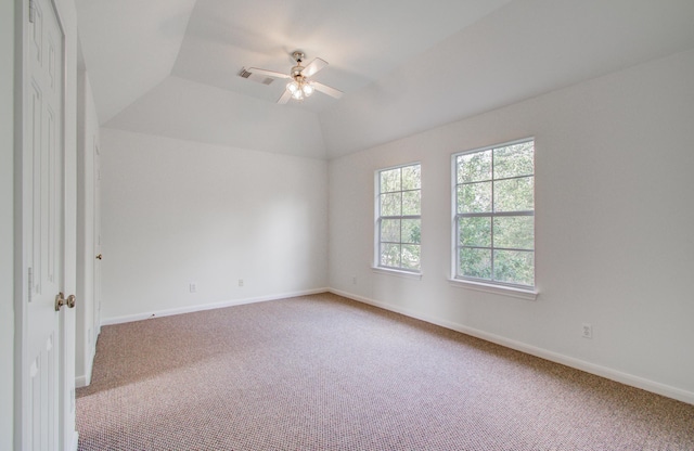 spare room featuring lofted ceiling, carpet floors, and ceiling fan