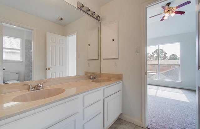 bathroom featuring vanity, a wealth of natural light, ceiling fan, and toilet