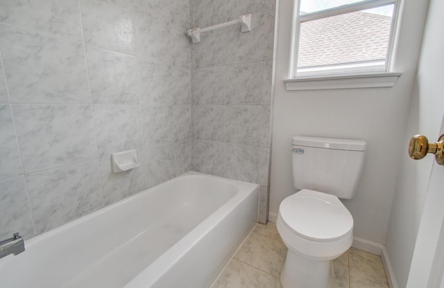 bathroom featuring tiled shower / bath combo, tile patterned floors, and toilet