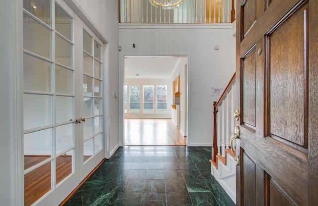 entrance foyer with french doors and a high ceiling