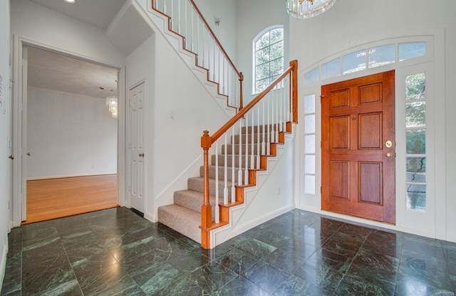 entryway featuring a towering ceiling