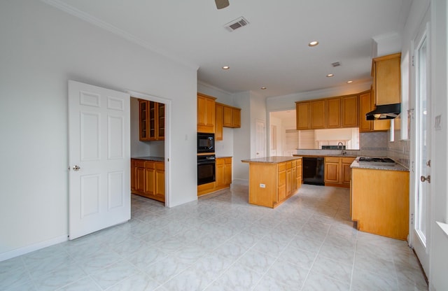 kitchen with backsplash, ornamental molding, black appliances, and a center island