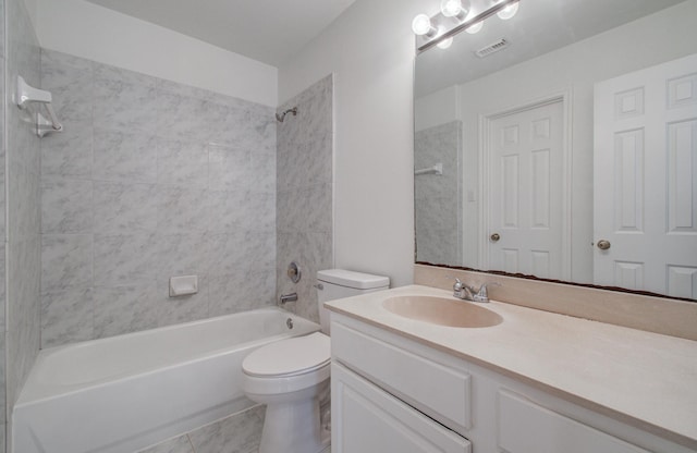 full bathroom featuring tiled shower / bath, vanity, and toilet