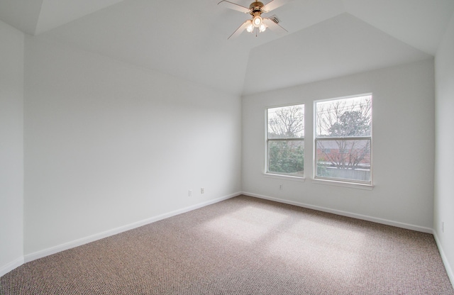 carpeted spare room featuring lofted ceiling and ceiling fan