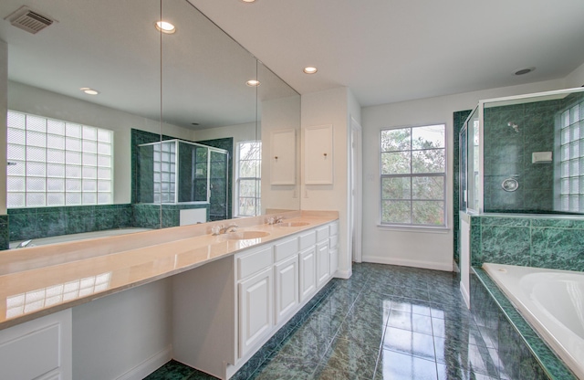 bathroom with independent shower and bath and vanity