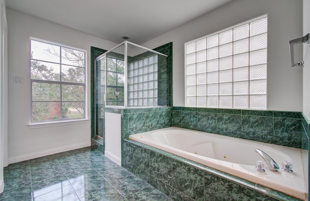 bathroom featuring independent shower and bath