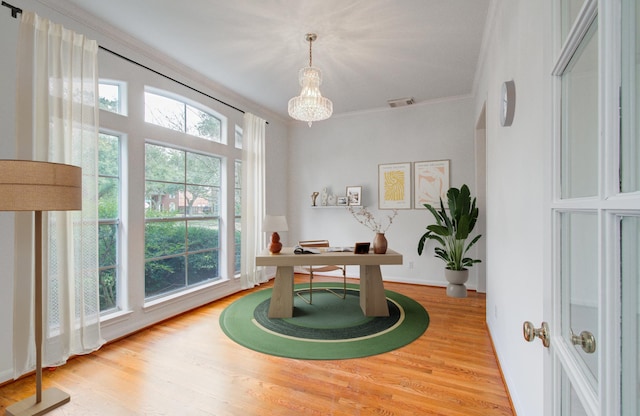 office area featuring crown molding and light hardwood / wood-style flooring