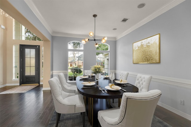 dining room with an inviting chandelier, dark hardwood / wood-style flooring, and ornamental molding