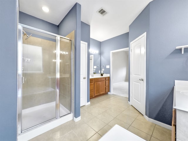 bathroom featuring vanity, an enclosed shower, and tile patterned flooring