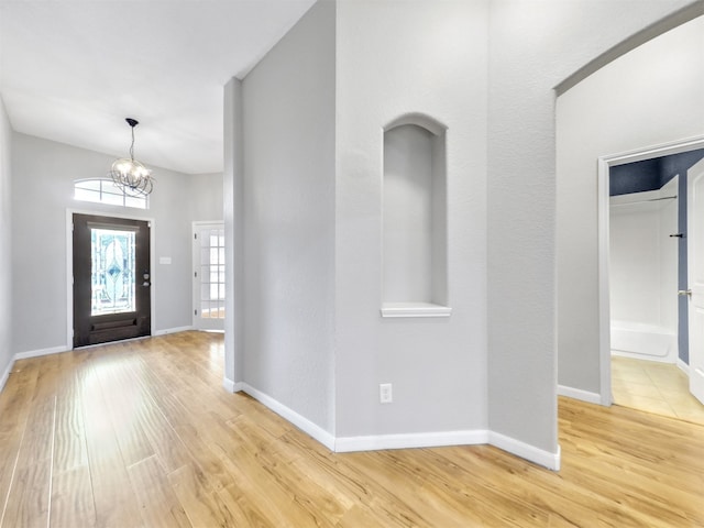 entryway featuring light hardwood / wood-style floors and a chandelier