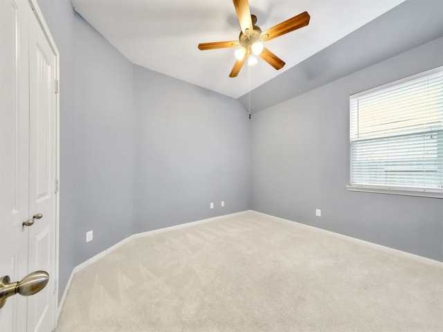 unfurnished room featuring ceiling fan, lofted ceiling, and carpet flooring