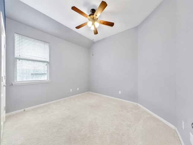 unfurnished room featuring ceiling fan, vaulted ceiling, and light carpet