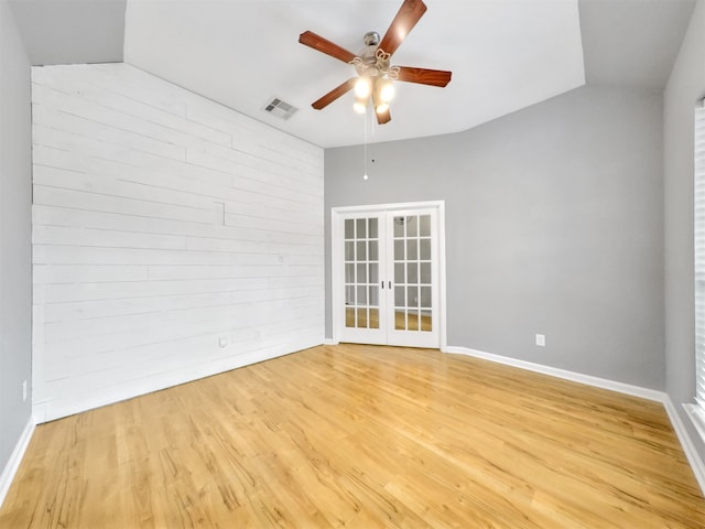 unfurnished room with lofted ceiling, light hardwood / wood-style flooring, french doors, and ceiling fan