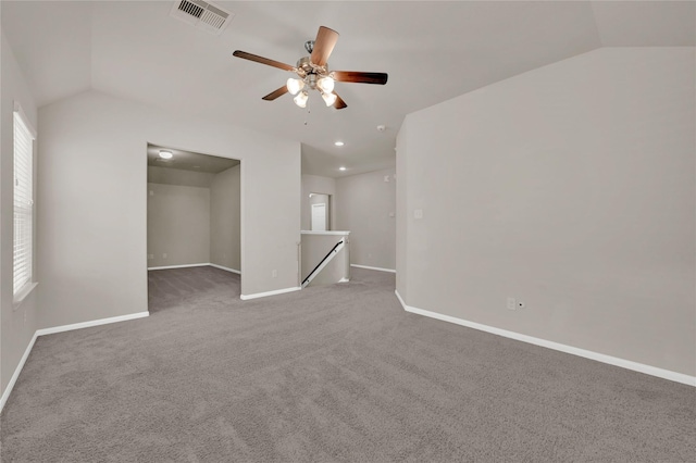 carpeted spare room featuring lofted ceiling and ceiling fan