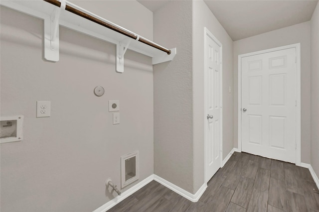 clothes washing area featuring wood-type flooring, hookup for a gas dryer, hookup for a washing machine, and electric dryer hookup