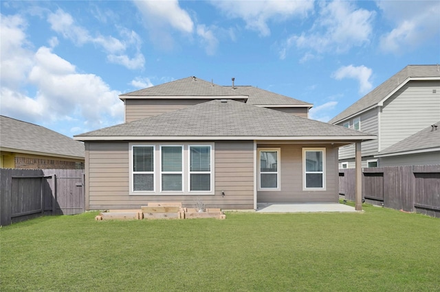 back of house featuring a yard and a patio