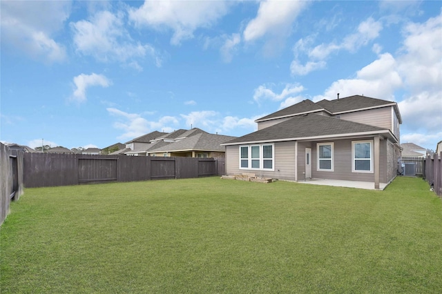 rear view of property with a patio and a lawn