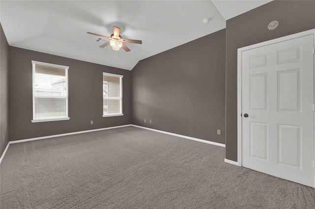 carpeted empty room featuring lofted ceiling and ceiling fan