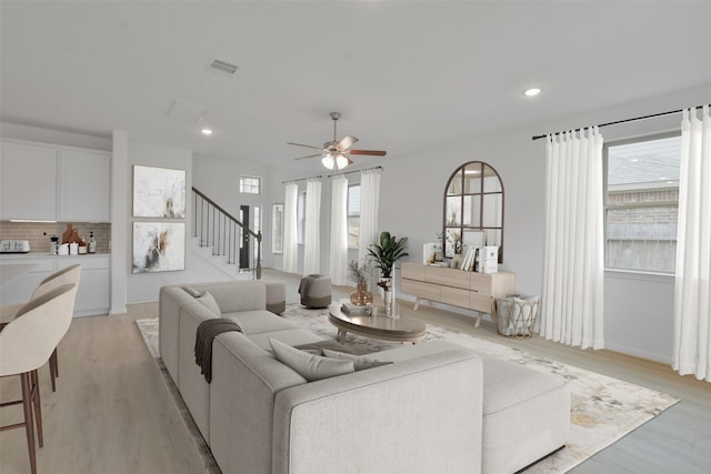 living room featuring ceiling fan and light wood-type flooring