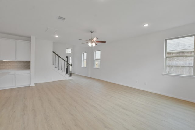 unfurnished living room with ceiling fan and light wood-type flooring