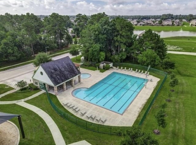 view of swimming pool with a water view, a yard, and a patio area