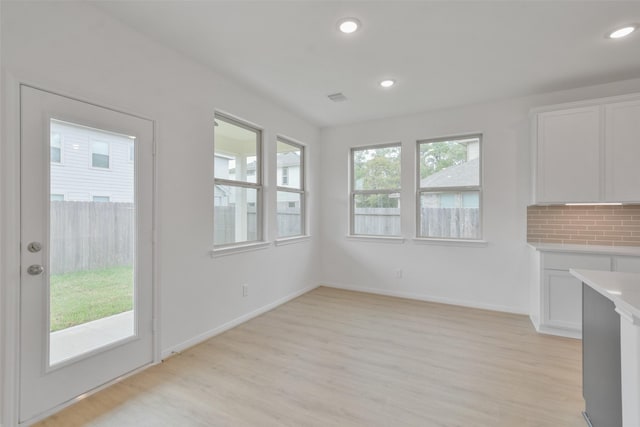 unfurnished living room featuring light wood-type flooring