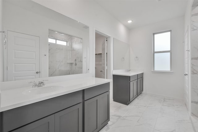 bathroom featuring vanity, a wealth of natural light, and tiled shower