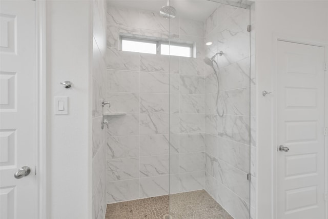 bathroom with tiled shower