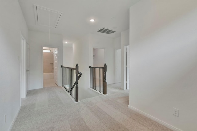 hallway with light colored carpet