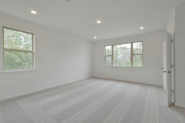 spare room with light colored carpet