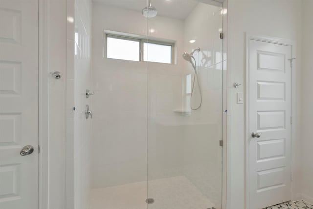 bathroom with a shower with door