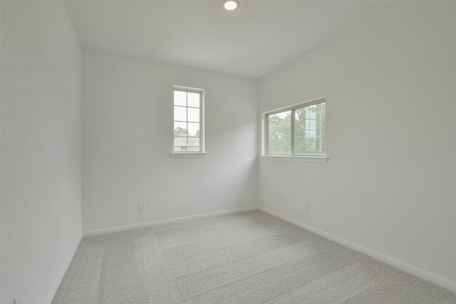 unfurnished room with light colored carpet