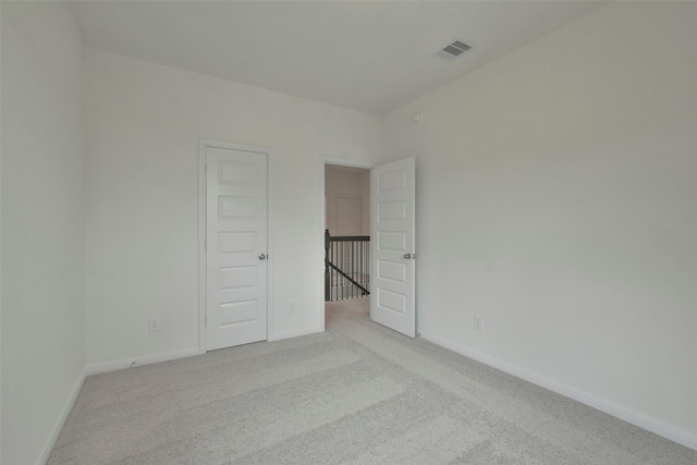 empty room featuring light carpet