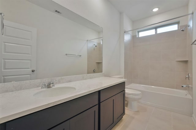 full bathroom with tiled shower / bath combo, vanity, tile patterned floors, and toilet