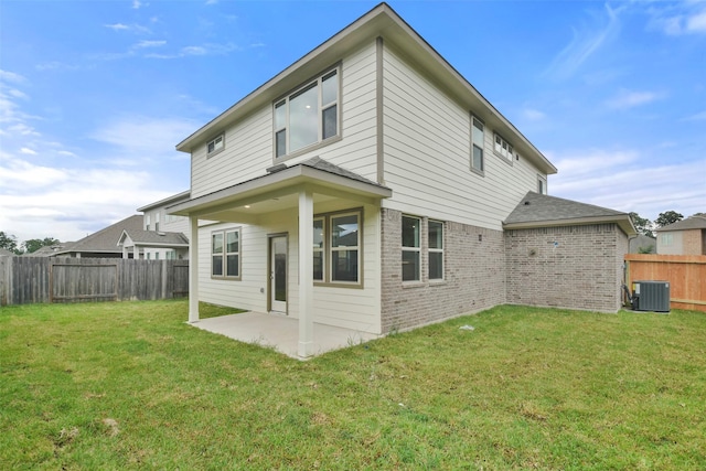 back of house featuring central AC unit, a yard, and a patio