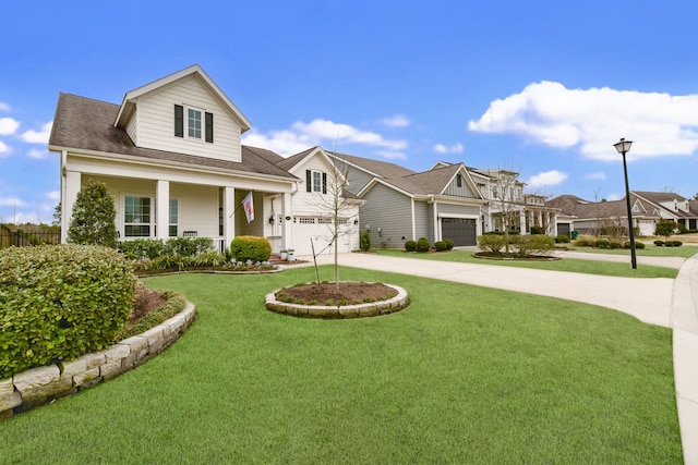 view of front facade with a garage, covered porch, and a front lawn