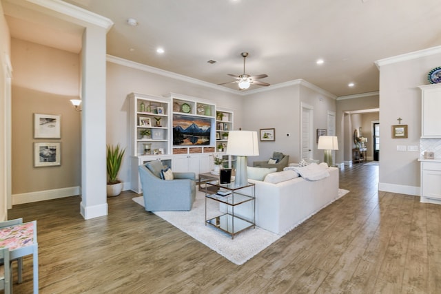 living room featuring hardwood / wood-style floors, ornamental molding, and ceiling fan