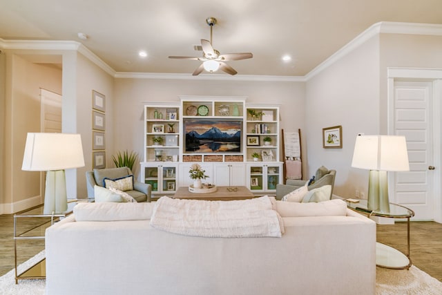 living room featuring ceiling fan, ornamental molding, and wood-type flooring