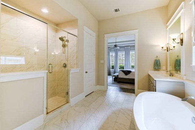 bathroom featuring vanity, ceiling fan with notable chandelier, and shower with separate bathtub