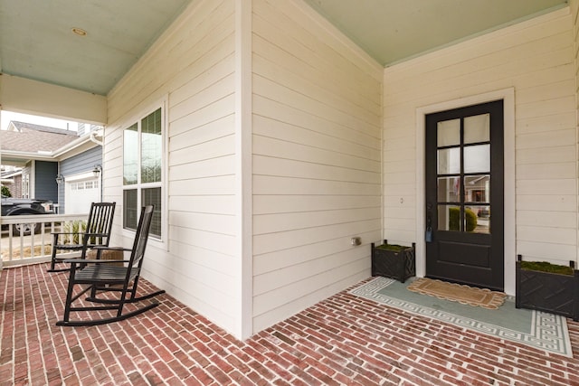 view of exterior entry with a porch