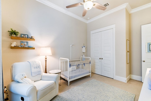 bedroom with ornamental molding, a nursery area, light carpet, and a closet